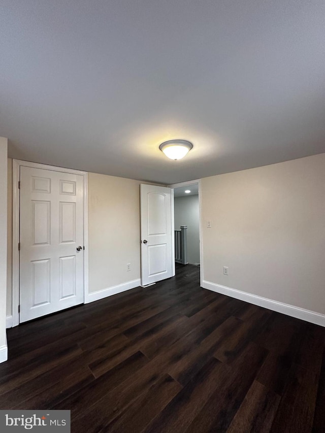 unfurnished room featuring dark hardwood / wood-style floors