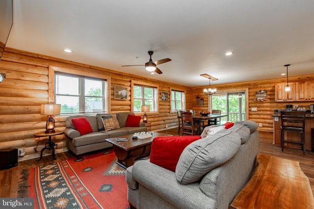 living room featuring plenty of natural light, rustic walls, and dark hardwood / wood-style flooring