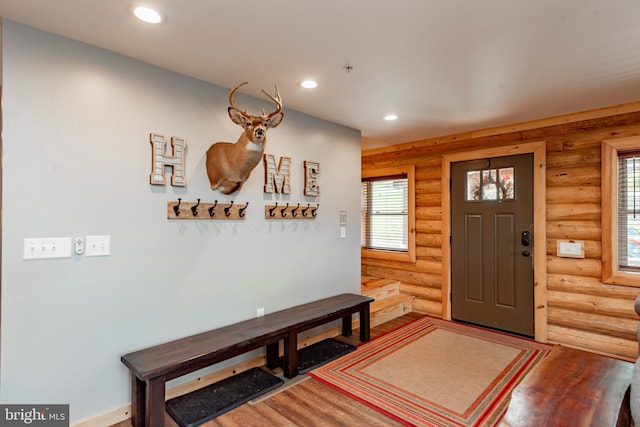 foyer featuring hardwood / wood-style floors and log walls