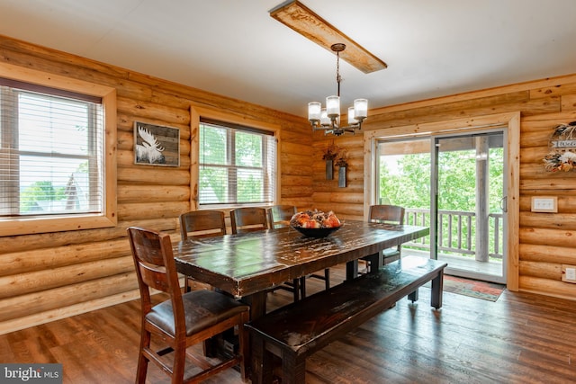 dining area with hardwood / wood-style floors, a chandelier, and plenty of natural light