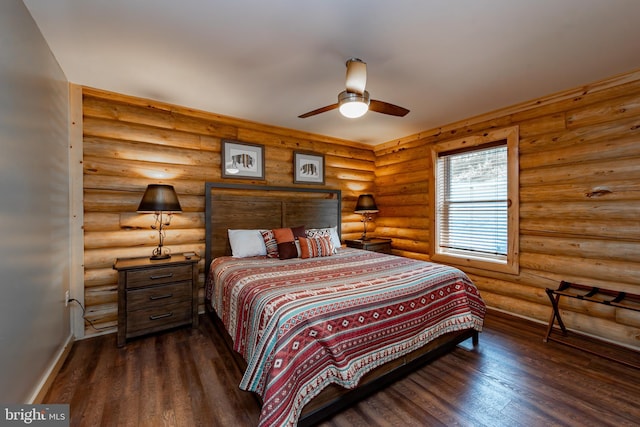 bedroom with dark hardwood / wood-style floors, rustic walls, and ceiling fan