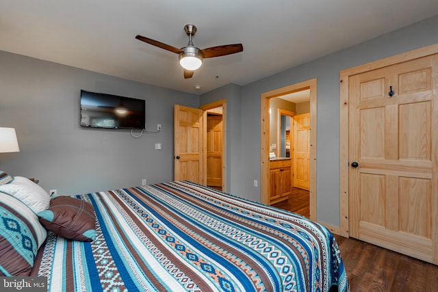 bedroom featuring connected bathroom, dark wood-type flooring, and ceiling fan