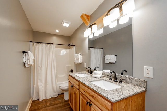 full bathroom with toilet, hardwood / wood-style flooring, vanity, and shower / bath combination with curtain