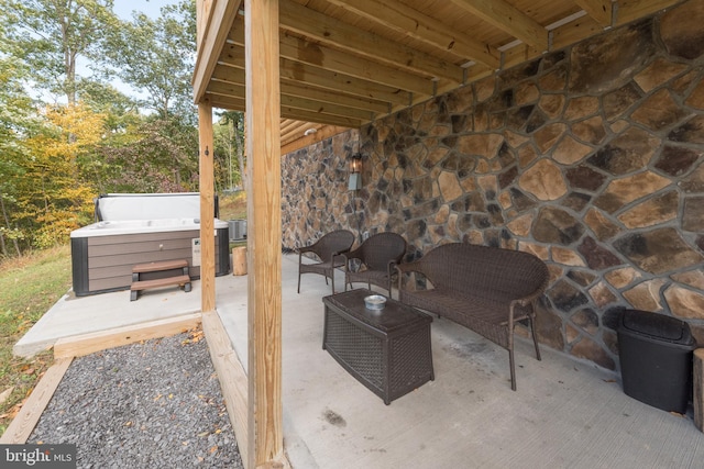 view of patio / terrace with central air condition unit and a hot tub