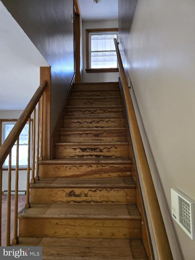 stairs featuring wood-type flooring