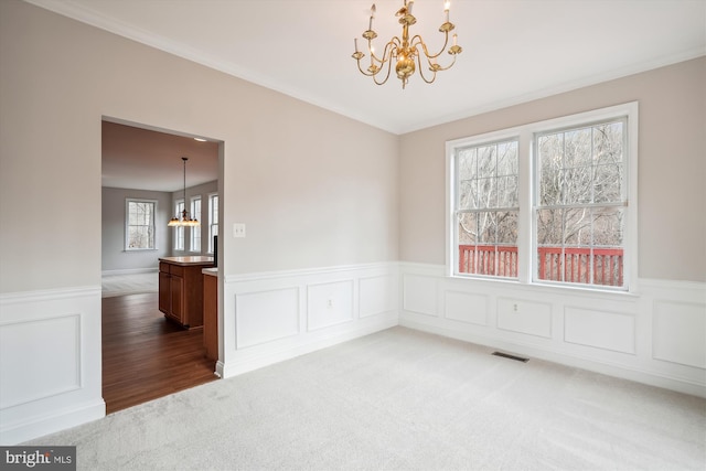 empty room featuring hardwood / wood-style floors and an inviting chandelier