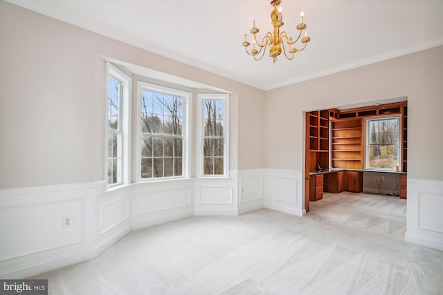 unfurnished dining area with carpet, plenty of natural light, and a chandelier