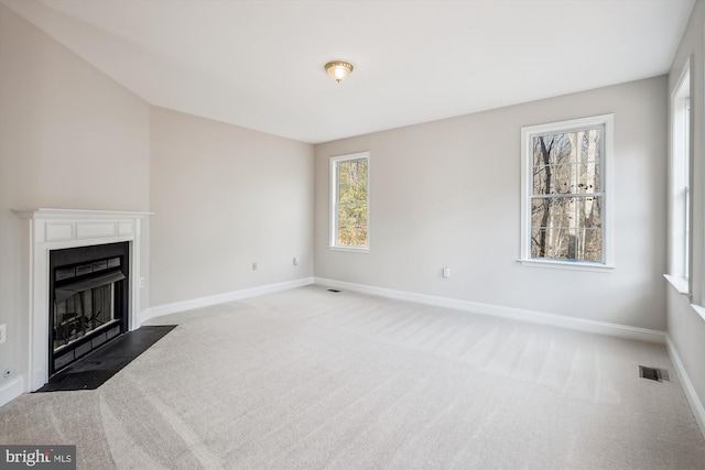 unfurnished living room featuring carpet floors