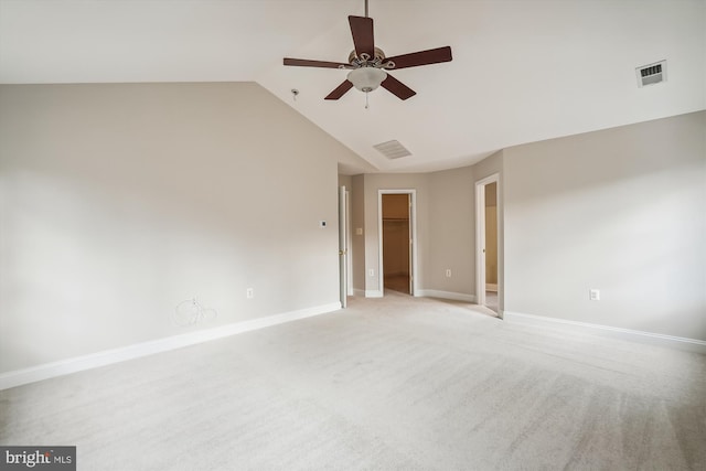 carpeted spare room with ceiling fan and high vaulted ceiling