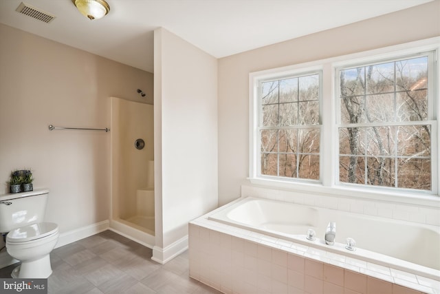 bathroom featuring plenty of natural light, toilet, and independent shower and bath