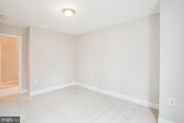 unfurnished room with light colored carpet