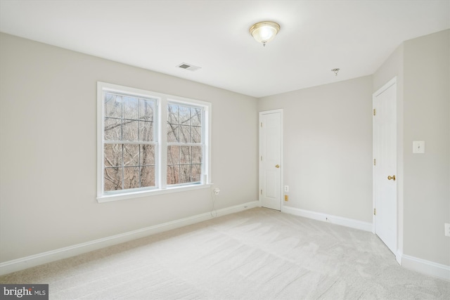 unfurnished room featuring light colored carpet