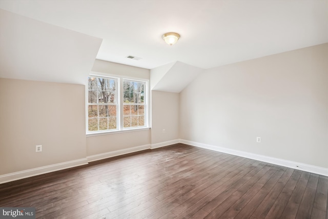 bonus room featuring dark hardwood / wood-style flooring and vaulted ceiling