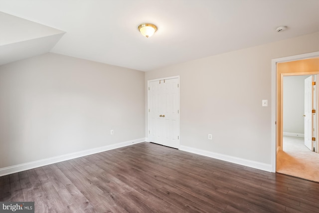 interior space featuring vaulted ceiling and dark hardwood / wood-style floors