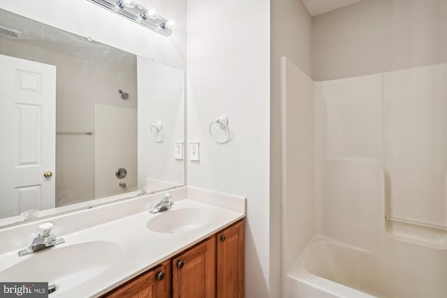 bathroom featuring bathtub / shower combination and vanity