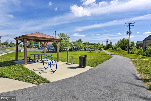 surrounding community with a gazebo and a yard