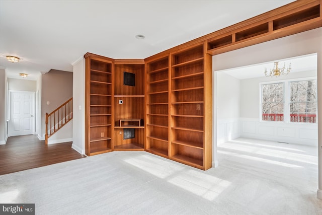 unfurnished room with a notable chandelier and hardwood / wood-style flooring