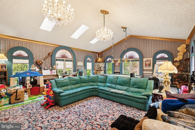 carpeted living room with ornamental molding, a chandelier, vaulted ceiling with skylight, and a textured ceiling