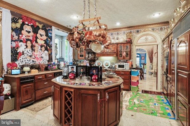 kitchen with crown molding, a center island, a textured ceiling, and black oven