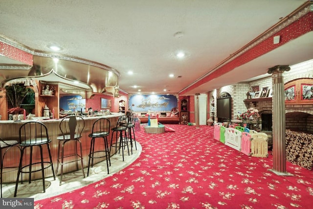 interior space with a fireplace, a textured ceiling, crown molding, brick wall, and carpet