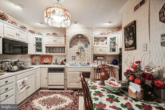 kitchen with black appliances, crown molding, and pendant lighting