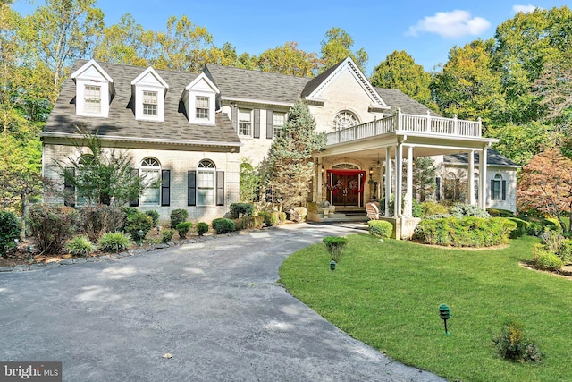 view of front of home with a porch and a front yard