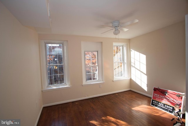 unfurnished room featuring dark wood-type flooring and ceiling fan