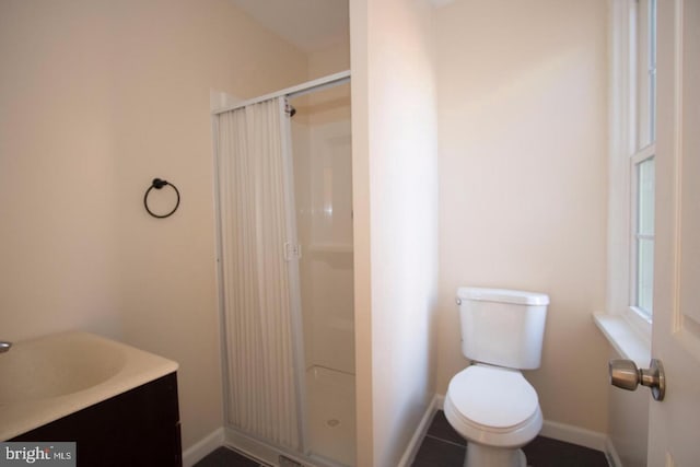 bathroom with vanity, toilet, and a shower