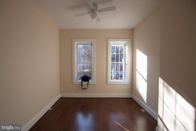 empty room featuring ceiling fan and dark hardwood / wood-style flooring