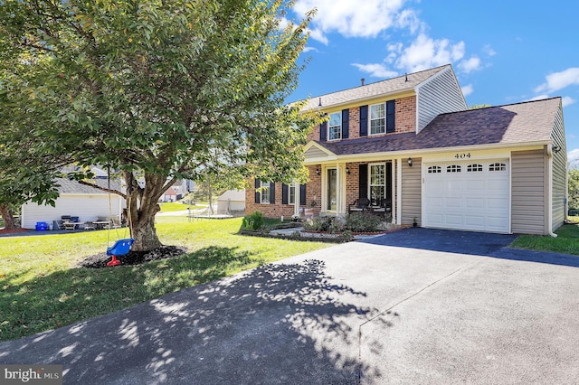 view of front of home with a garage and a front lawn