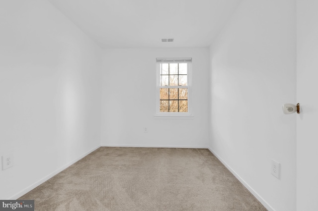 empty room featuring light carpet