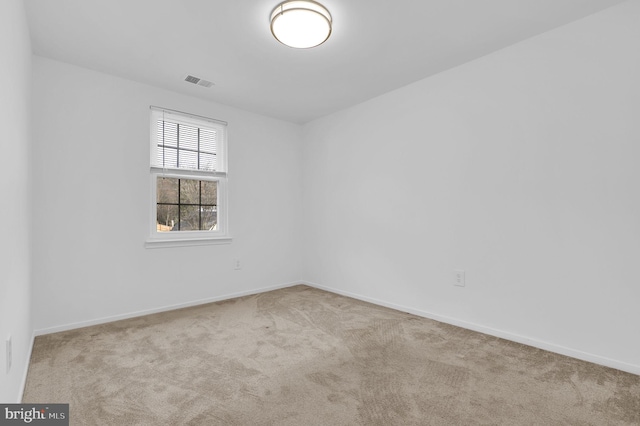 unfurnished room featuring light carpet