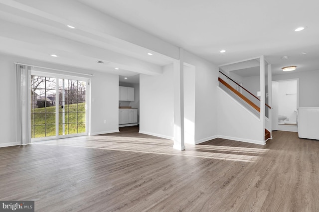 unfurnished living room featuring hardwood / wood-style flooring