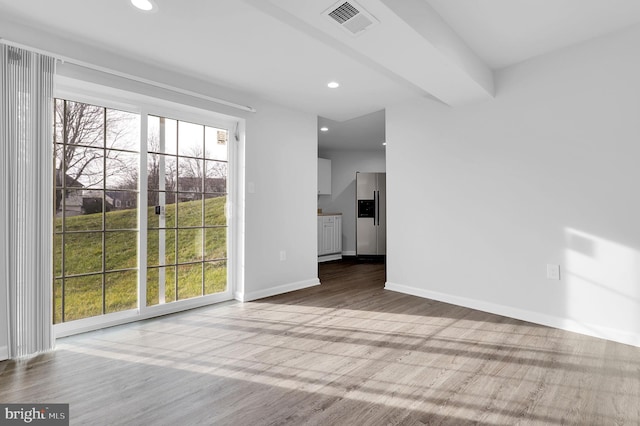 interior space featuring hardwood / wood-style flooring and beamed ceiling