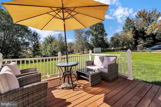 deck with a lawn, outdoor lounge area, and a storage unit