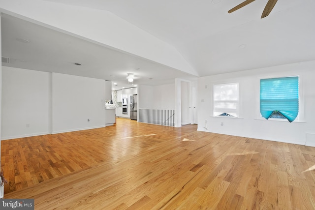 unfurnished living room with ceiling fan, light hardwood / wood-style floors, and lofted ceiling