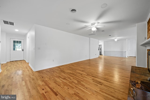 unfurnished living room featuring ceiling fan and light hardwood / wood-style floors