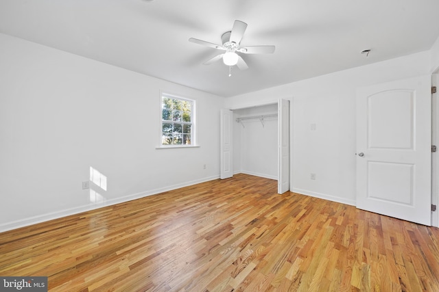 unfurnished bedroom featuring ceiling fan, a closet, and light hardwood / wood-style flooring