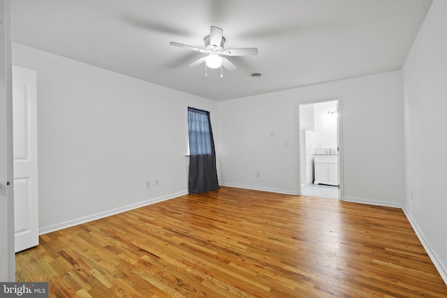 spare room featuring ceiling fan and light hardwood / wood-style flooring