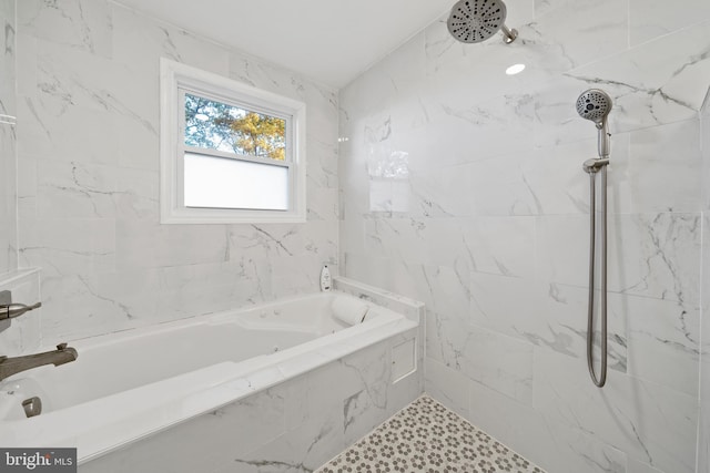 bathroom featuring shower with separate bathtub