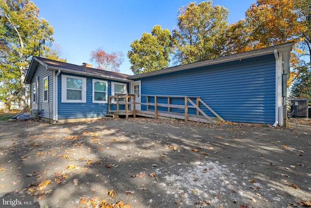 view of front of house with central AC and a wooden deck