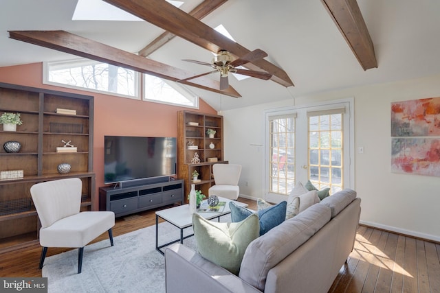 living area with vaulted ceiling with skylight, wood-type flooring, and a wealth of natural light