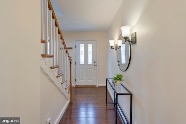 entryway featuring dark wood-style floors, stairs, and baseboards