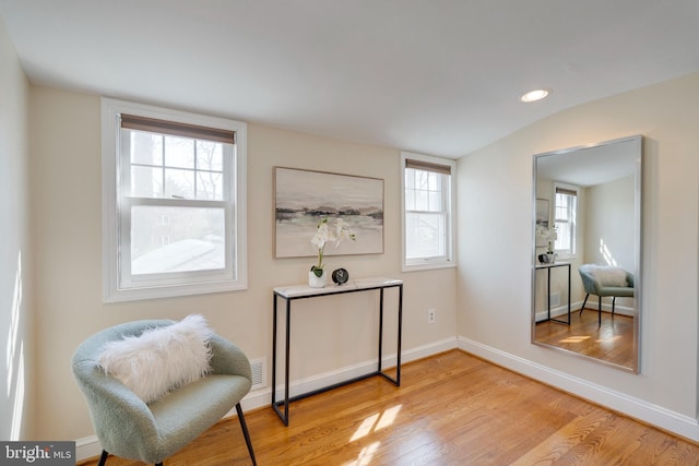 living area with lofted ceiling, recessed lighting, light wood-style flooring, and baseboards