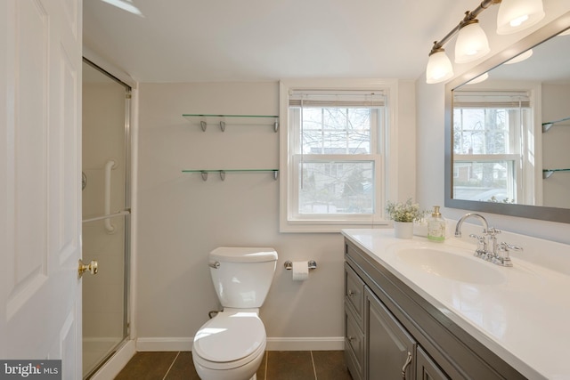 full bathroom with vanity, tile patterned floors, a shower with shower door, and a healthy amount of sunlight