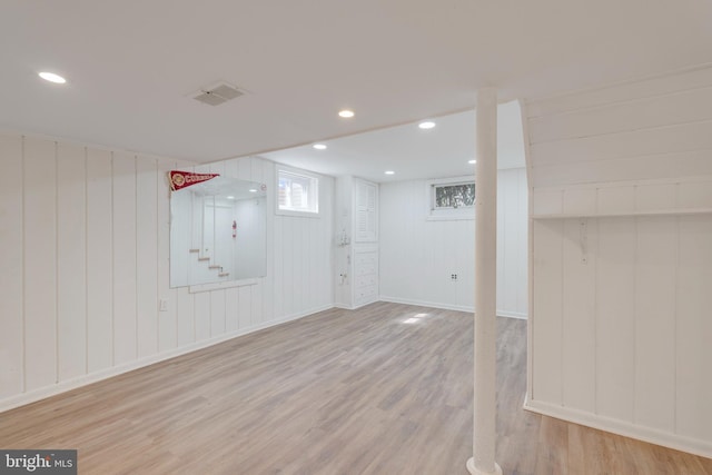 basement featuring light wood-type flooring, visible vents, baseboards, and recessed lighting