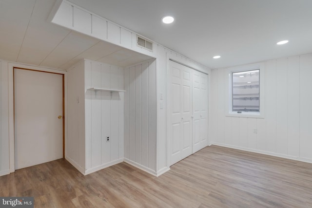 unfurnished bedroom with light wood-type flooring, a closet, visible vents, and recessed lighting