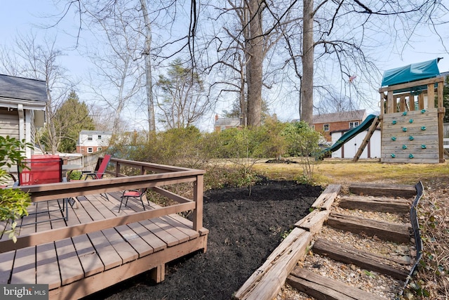 view of yard with a deck and a playground