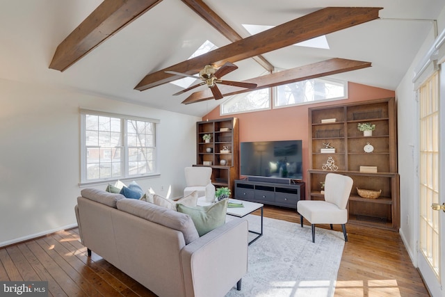 living area featuring lofted ceiling with beams, ceiling fan, and hardwood / wood-style floors