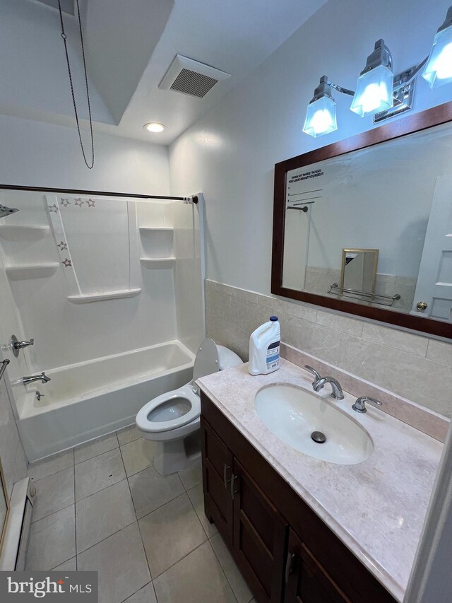 full bathroom with bathing tub / shower combination, a baseboard heating unit, toilet, vanity, and tile patterned flooring